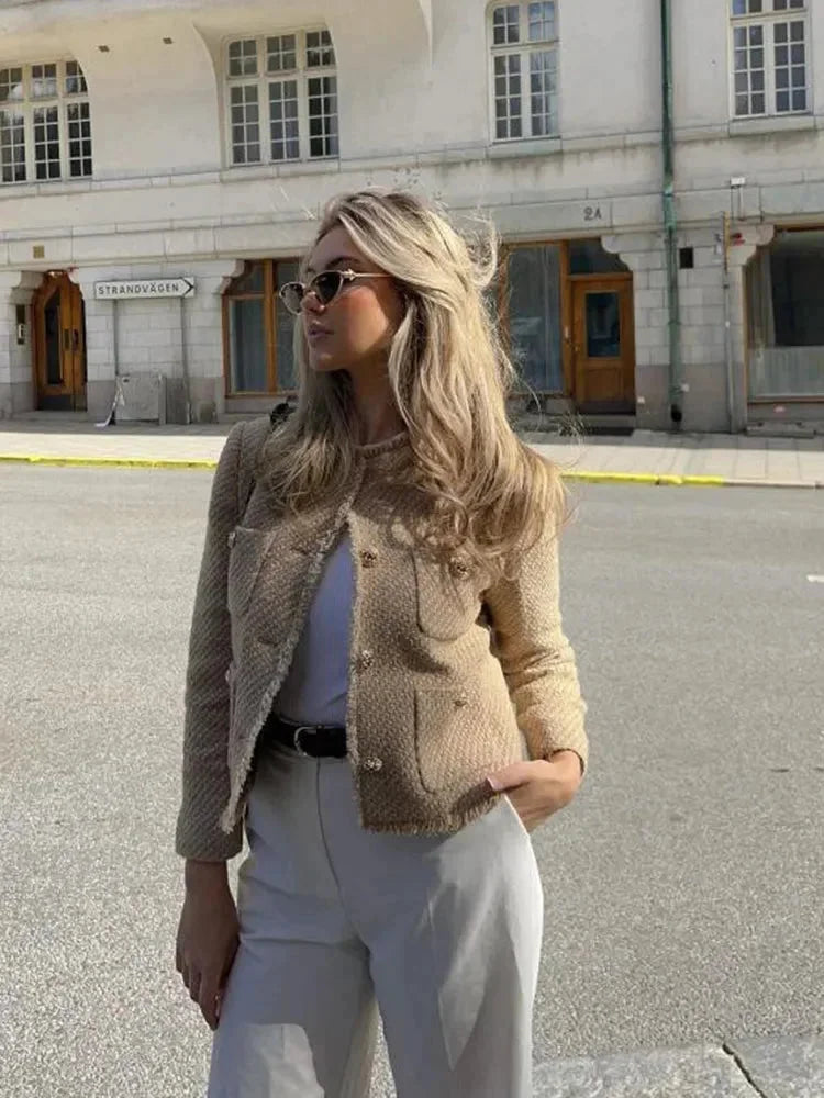Veste femme en tweed beige avec boutons, coupe classique adaptée à des tenues quotidiennes variées.