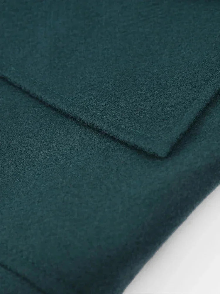 Dunkelgrüne Damenjacke mit Faltenwurf, kragen aus Kunstfell und praktischen Seitentaschen für zusätzlichen Komfort.