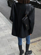 Veste surdimensionnée en simili cuir noir pour femme avec col moderne et style décontracté.