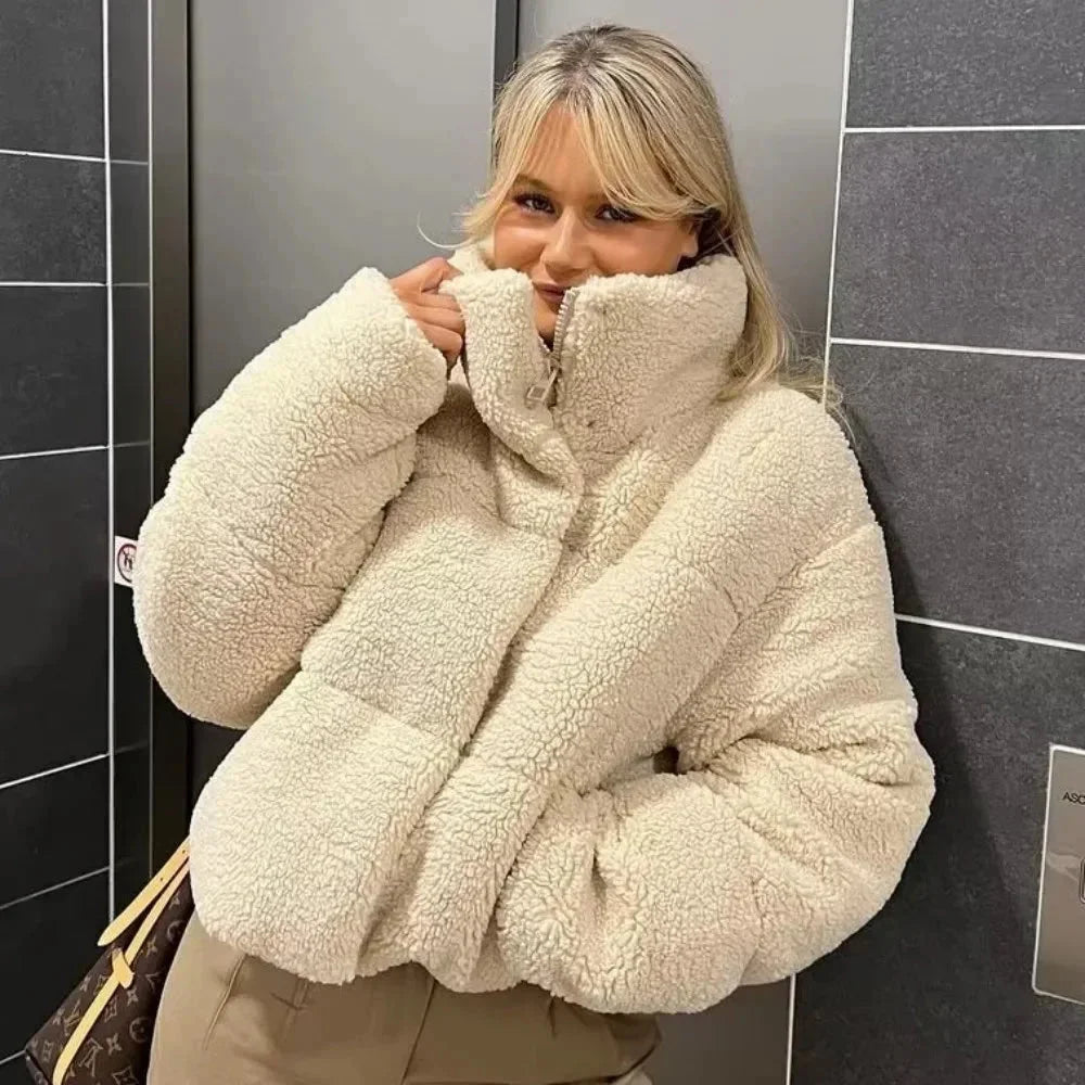 Beige teddy pufferjacke für Damen mit hohem Kragen, weichem Material und modischem Steppdesign für zusätzlichen Wärmeschutz.